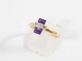 an image of a yellow gold ring with a purple stone and a diamond