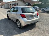 a small silver car parked on the side of the road