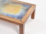 a wooden table with a blue and yellow design on it