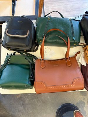 a lot of purses and shoes on a table