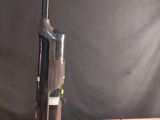 a vacuum that is sitting on a wooden table