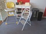 a baby ' s high chair and a table in a room