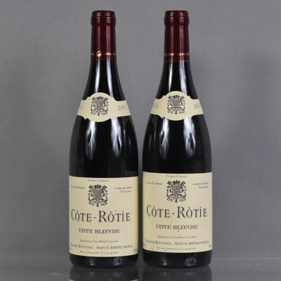 two bottles of wine sitting on top of a table