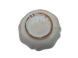 a white bowl with a brown rim on a white surface