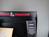 a sign that says dragons on the front of a piano