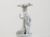 a statue of a man holding a plant in his hand