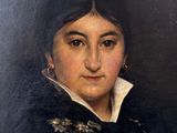 portrait of a woman in a black dress with a white collar