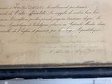 an old document with writing on it sitting on a table