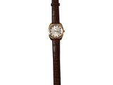 une montre montée sur un bracelet en cuir marron