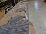 many boxes of carpet on the floor in a warehouse