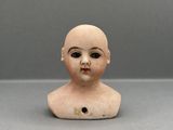 an image of a small clay head of a child