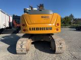 the back end of a yellow construction vehicle parked in a parking lot