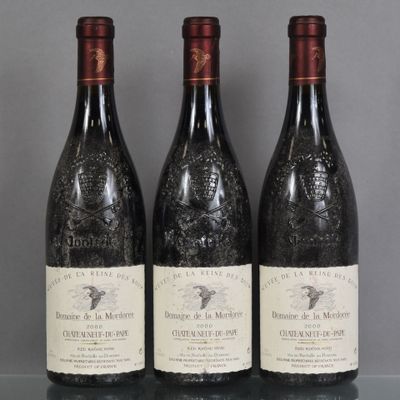 three bottles of wine are sitting on a glass table