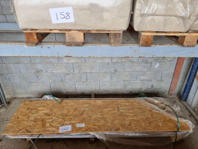 two mattresses sitting on pallets in a warehouse
