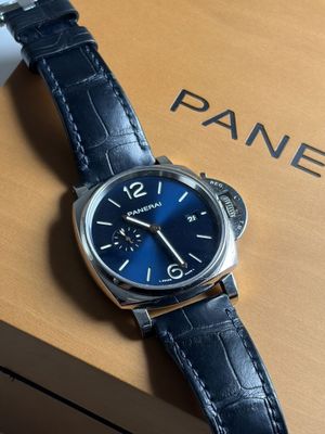 the watch is sitting on top of a box on the table