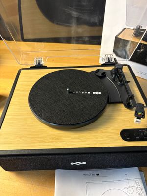a record player sitting on top of a wooden table