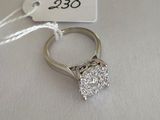 a close up of a diamond ring on a table with a price tag