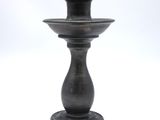 a black vase that is sitting on a white table
