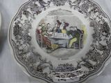 a plate with a picture of a group of people sitting at a table