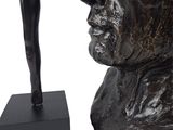 statue of a man with a hat on his head and a stick in his hand