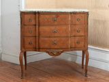 a marble top chest of drawers in a room