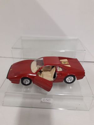 a red toy car in a clear box on a table