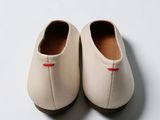a close up of a pair of white shoes on a white surface
