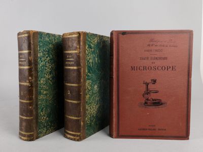 two old books sitting next to each other on a white surface