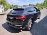 the rear end of a black audi qx parked in a parking lot