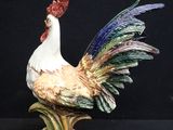 a figurine of a rooster on a black background