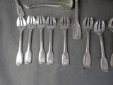 a lot of forks and spoons that are on the table