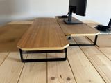 a computer desk with a monitor and keyboard on it