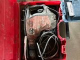 a red tool box with tools in it on the floor