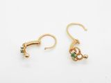 two pairs of gold earrings with green and white stones on them