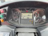 a close up of a motorcycle dashboard with a clock on it