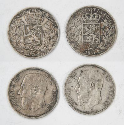 four different types of silver coins on a white surface