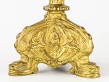 a gold candle holder on a white background