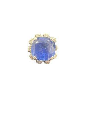 a close up of a ring with a blue stone in it