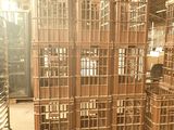 many wooden crates stacked on pallets in a warehouse