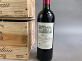 a bottle of wine sitting next to two wooden boxes