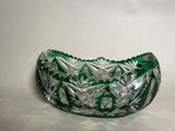 a green glass bowl on a white surface