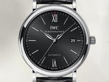 a close up of a black watch with roman numerals on the face