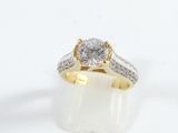 a close up of a diamond ring on a white surface