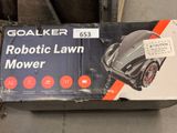 a box with a robotic lawn mower inside of it