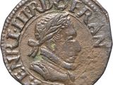 a silver coin with an image of a man on it