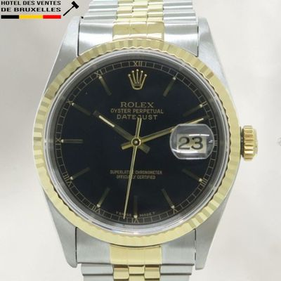 une photo d'une montre Rolex avec un cadran noir et un bracelet bicolore