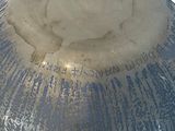 a large blue vase with writing on it sitting on a table
