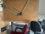 a desk with a chair and a large clock on it