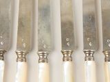 five knives that are sitting next to each other on a table