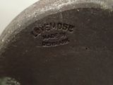 a close up of a metal object with a name on it